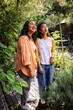 © Wavebreak Media - Grandmother and asian female teenager enjoying nature walk together in lush garden