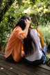 © Wavebreak Media - Grandmother and asian female teenager sharing heartfelt moment outdoors in lush garden