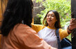 © Wavebreak Media - asian female teenager greeting grandmother with hug at home, smiling and holding backpack