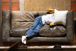 © Wavebreak Media - asian female teenager relaxing on couch at home, covering face with pillow, smartphone nearby