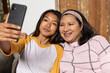 © Wavebreak Media - asian female teenager taking selfie with grandma at home, both smiling and enjoying time together