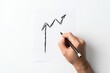 © vinod - hand drawing an upward trend line on paper