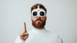 © Sergio - A man wearing virtual reality goggles stands in a bright, minimalistic environment, raising one finger as if indicating a point or directing attention. His thoughtful expression suggests immersion.