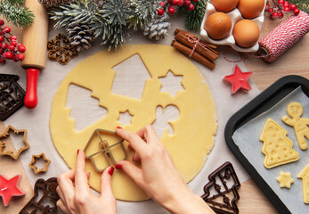 Wall Mural - Pastry chef making christmas cookies using dough cutters