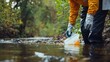 © aubriella - A person participating in a river cleanup to protect freshwater ecosystems, Symbolizing environmental stewardship and water conservation, photography style