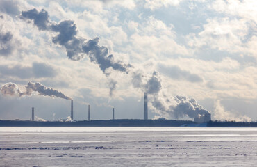 Wall Mural - A large cloud of smoke is rising from a factory