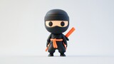 A cute cartoon ninja figure in black attire with an orange belt and sword.