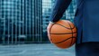 © Anurak - Basketball player in suit holding ball urban setting sports photography business environment close-up view ambition and style