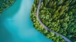 © EUT - Aerial view of road winding by lake. Perfect for travel, nature, or environmental themes; evokes serenity and adventure.