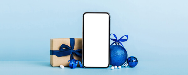 Wall Mural - Digital phone mock up with rustic Christmas decorations for app presentation with empty space for you design. Christmas online shopping concept. Tablet with copy space on colored background