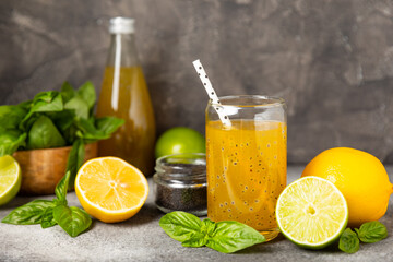 Wall Mural - Diet detox cocktail with basil and chia seeds in a glass jar and a glass on a textured background. Drink with seeds. Health food. Detox cocktail. Antioxidant. Water with basil. Space for text. 