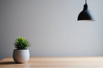 Wall Mural - a minimalist scene featuring a potted plant and a pendant lamp on a wooden table.