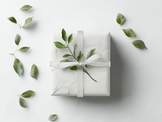 Wall Mural - White elegant gift box with a white ribbon and green tender leaves isolated on white background