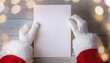 © Viktoriia - Santa's hands in white gloves holding a white card. Christmas background. Free space for text. New Year postcard.  Flat lay.