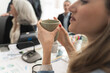 © Lomb - Professional businesswoman taking coffee break during meeting showing work life balance and workplace wellness modern culture