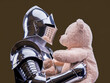 © GianPiero - Knight holding teddy bear in shiny armor
