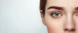 © MonkaLemonka - portrait of a half face of blue eyes natural beauty woman looking directly; perfect young female skin isolated over white background