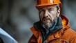 © tanongsak - Construction worker analyzing blueprint industrial site portrait photography urban environment close-up perspective professionalism
