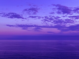 Wall Mural - dusk sky clouds over calm ocean at evening