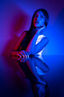 © FATIR29 - High Fashion model woman in colorful bright neon blue and purple lights posing in studio. Portrait of beautiful woman with trendy glowing make-up. Art design vivid style
