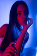 © FATIR29 - High Fashion model woman in colorful bright neon blue and purple lights posing in studio. Portrait of beautiful woman with trendy glowing make-up. Art design vivid style