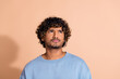 © deagreez - Photo of dreamy suspicious guy dressed blue sweatshirt looking empty space isolated beige color background