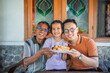 © Odua Images - happy asian family spending leisure time together, grandfather, son, and granddaughter