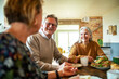 © Marko Geber - Group of senior friends enjoying breakfast together at home