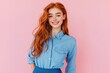 © Alla - A woman with long red hair is seen wearing a blue shirt, providing an image of casual attire