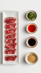 Wall Mural - きれいな白い背景に牛肉のスライスと各種ソースを盛り付けた料理の盛り合わせ