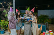 © Odua Images - Friends and family joyfully gather in festive hats, enjoying each others company warmly