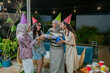 © Odua Images - Friends happily celebrating together, filled with laughter and joy, at a festive gathering event