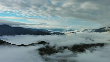 Wall Mural - flying between the clouds. aerial view of clouds and mountains at sunrise, panorama 4k
