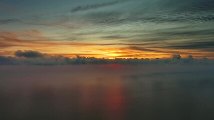 Wall Mural - aerial view of sea surface during a beautiful colourful sunset, timelapse, 4k