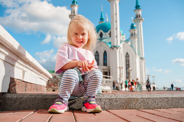 Wall Mural - Little girl child toddler travels with her family in Kazan at the Kul Sharif Mosque, Tatarstan, Russia.