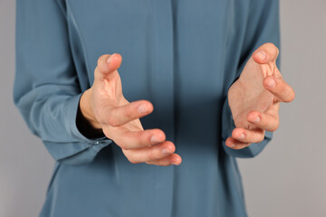 Wall Mural - man holding something on grey background, closeup