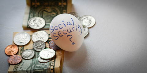 Wall Mural - close-up of money and coins with an egg and words social security and question mark business retirement topics background