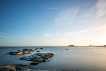 Wall Mural - Shore of a lake at sunrise. Landscape shot in the Narur in the morning. Forests lake and water at the beginning of winter or in autumn. Sweden, Scandinavia