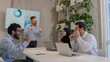 © Yuliia - Diverse multinational business company colleagues team co-workers celebrate achievement victory happy joyful businessmen and businesswoman in boardroom office partnership teamwork win successful deal