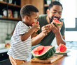 © Lumos sp - child family kitchen food boy son father mother watermelon fruit slice summer organic meal fun preparing healthy diet eating home black