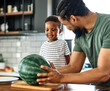 © Lumos sp - child family kitchen food boy son father watermelon fruit slice summer organic meal fun preparing healthy diet eating home black