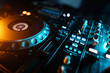 © goami - closeup of professional digital pioneer dj decks and audio mixer equipment ready for party in nightclub