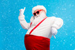 © deagreez - Photo of old man grey beard dance direct fingers raise hand wear santa claus x-mas costume cap headwear sunglass suspenders white shirt gloves isolated blue color background
