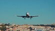 © creativeideh - Airplane Landing over Lisbon's Skyline