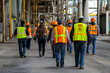 © Evhen Pylypchuk - Workers wearing high-visibility vests participating in an emergency evacuation drill at an industrial plant, emphasizing safety protocols and teamwork in risk preparedness.