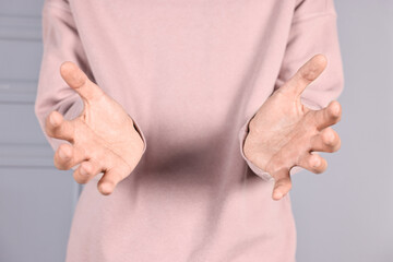 Wall Mural - man holding something on grey background, closeup