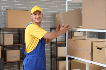 Wall Mural - Delivery man taking parcel box from shelf in warehouse