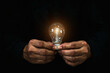 © Eakrin - Hand and light bulb with bright light for creative idea innovation of business plan analyzing marketing data management services to target growth concept.