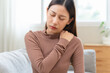 © Pormezz - muscles stiff problem, suffer young woman, girl face painful, hand holding neck ache from work hand holding massaging rubbing shoulder hurt, sore sitting on couch at home