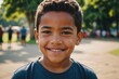 © ThomasLENNE - Close portrait of a smiling Tongan male kid looking at the camera, Tongan outdoors blurred background